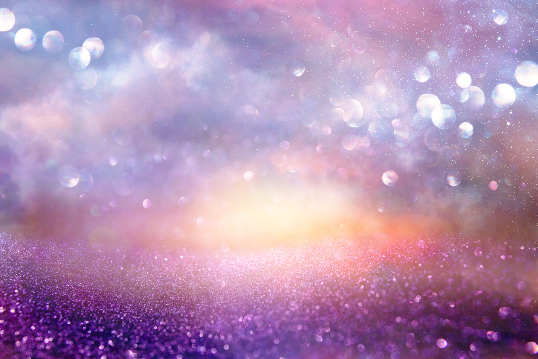 glitter vintage lights background. silver, purple and gold. de-focused.